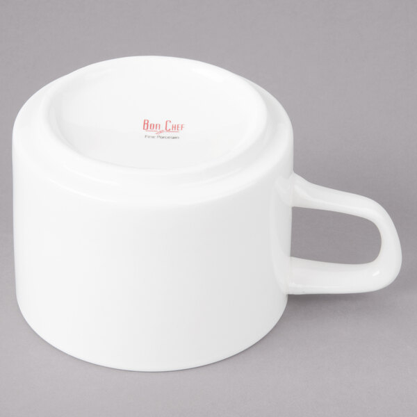 A white porcelain cup with a handle.