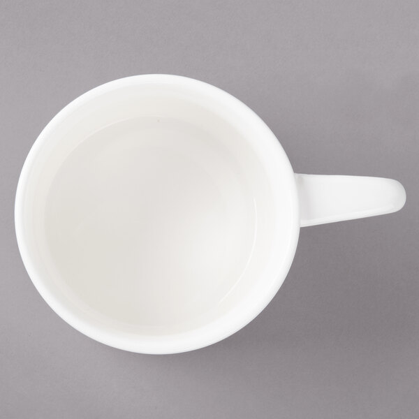 A white Bon Chef porcelain cup with a handle.