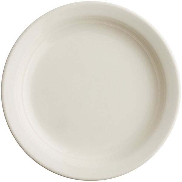 An Acopa ivory stoneware plate with a plain edge on a white surface.