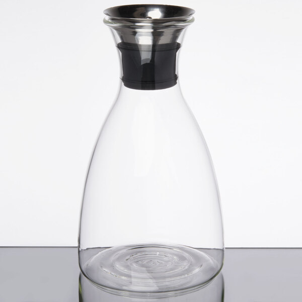A clear glass decanter with a stainless steel lid.
