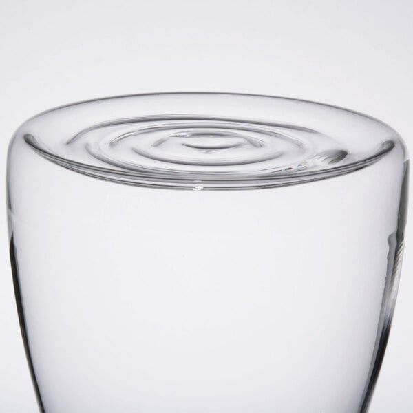 A glass of water with a clear glass base.