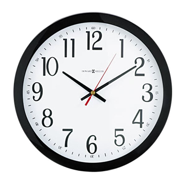 A close-up of a black and white clock with black hands and numbers.