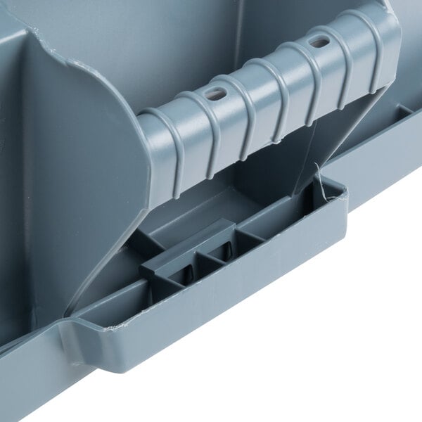 A gray Rubbermaid BRUTE square plastic trash container with a handle.