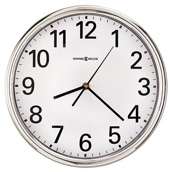 A Howard Miller silver wall clock with a white face and black clock hands with black numbers.