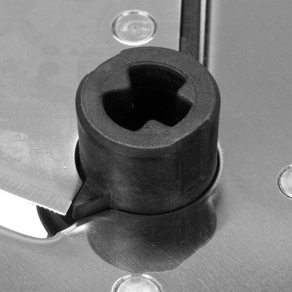 A close-up of a Waring adjustable slicing disc with a black circle on it.