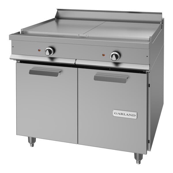 A heavy-duty stainless steel electric range with two top sections and a storage base.