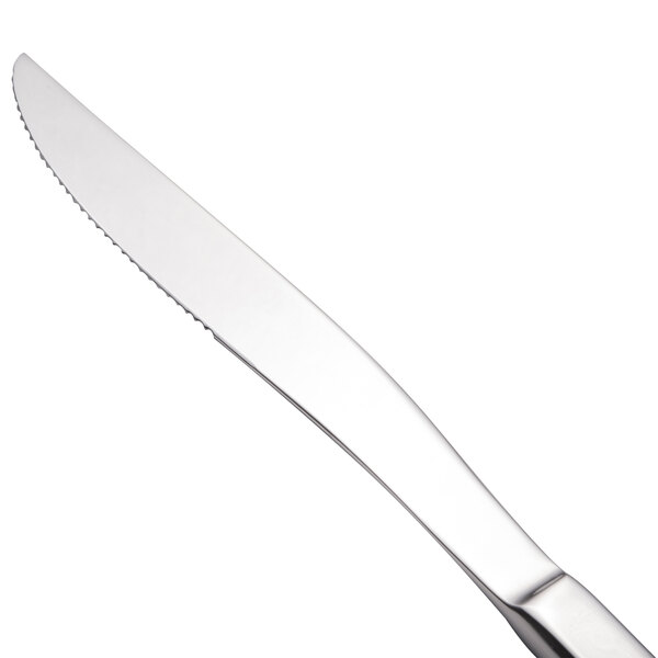 A close-up of a Walco stainless steel steak knife with a silver handle.