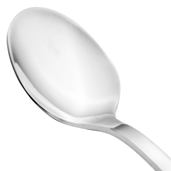 A close-up of a Walco stainless steel demitasse spoon with a silver handle.
