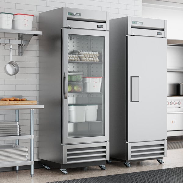 A True one section glass door reach-in refrigerator in a professional kitchen.