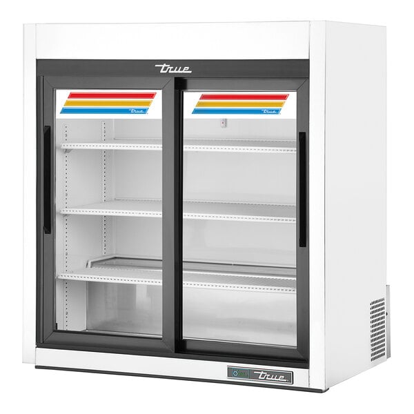 A white True countertop refrigerated merchandiser with sliding glass doors.