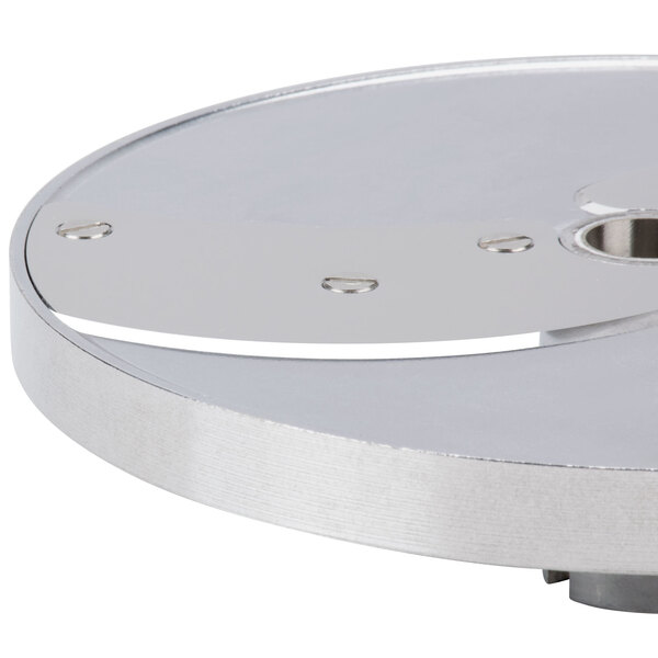A Robot Coupe 16-disc set for a commercial food processor, a circular metal object with holes in it.
