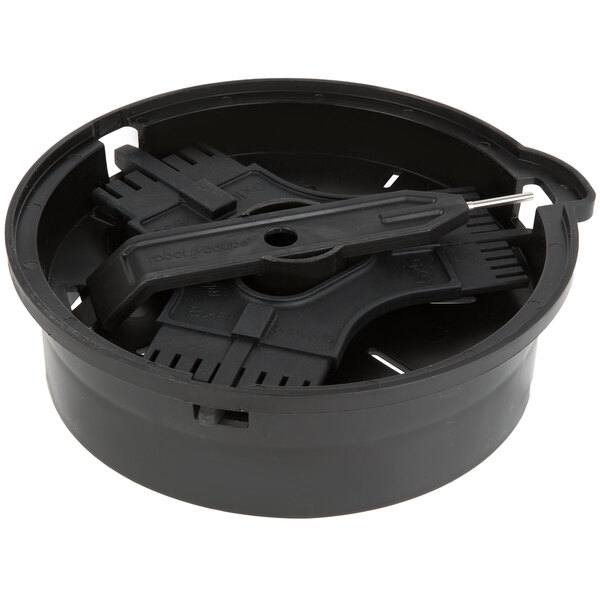 A black plastic round container with a black circular object inside and a screw-on top.