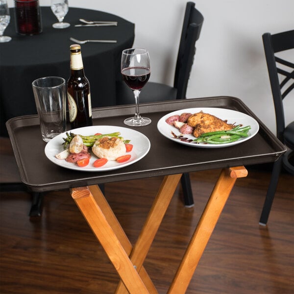 A Tavern Tan Cambro non-skid serving tray with food and wine on a table.