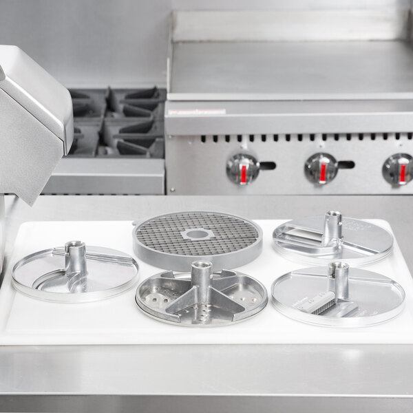 A Robot Coupe LP5DISC 5 disc set for a commercial food processor on a white surface.