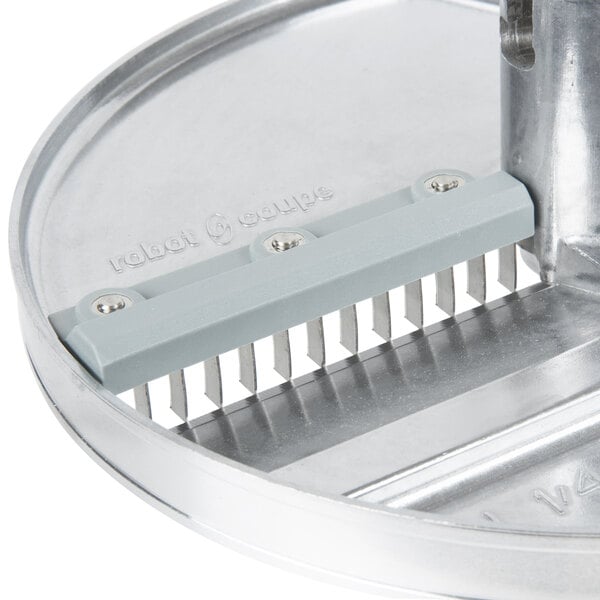 A Robot Coupe 5 disc set with a metal circular grater and grey handle.