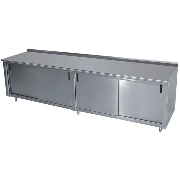 A stainless steel Advance Tabco work table with an enclosed base.