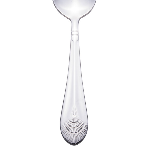 A Walco stainless steel teaspoon with an Art Deco design on the handle.