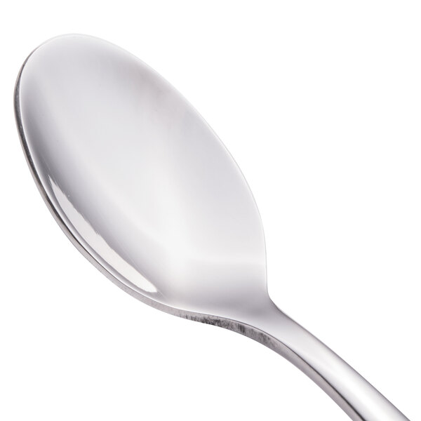 A close-up of a Walco stainless steel demitasse spoon with a silver handle.