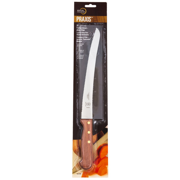 A Mercer Culinary Praxis bread knife with a wavy edge and a rosewood handle in a plastic case.