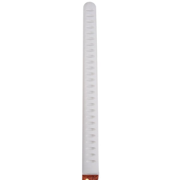 A white plastic tube with a red and white wristband.