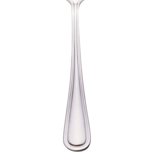 A Walco Pacific Rim stainless steel tablespoon with a white handle.