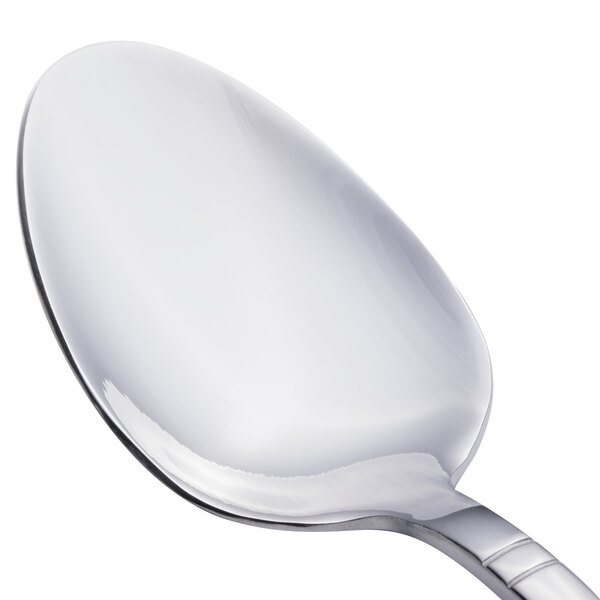 A close-up of a Walco stainless steel serving spoon with a silver handle.