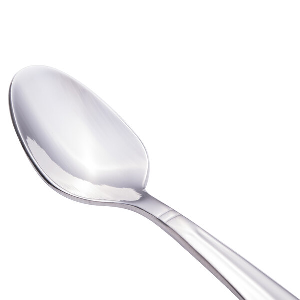 A close-up of a Walco stainless steel demitasse spoon with a silver handle.