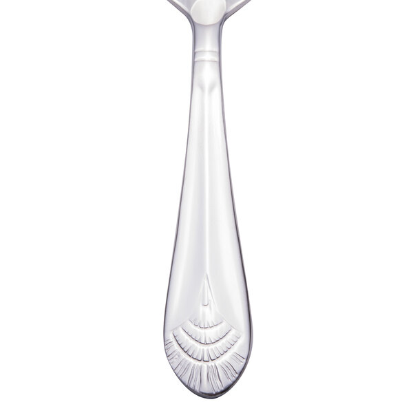 A Walco stainless steel demitasse spoon with a silver design on the handle.