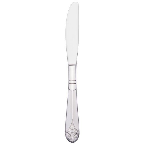 A silver Walco stainless steel table knife with a white handle.
