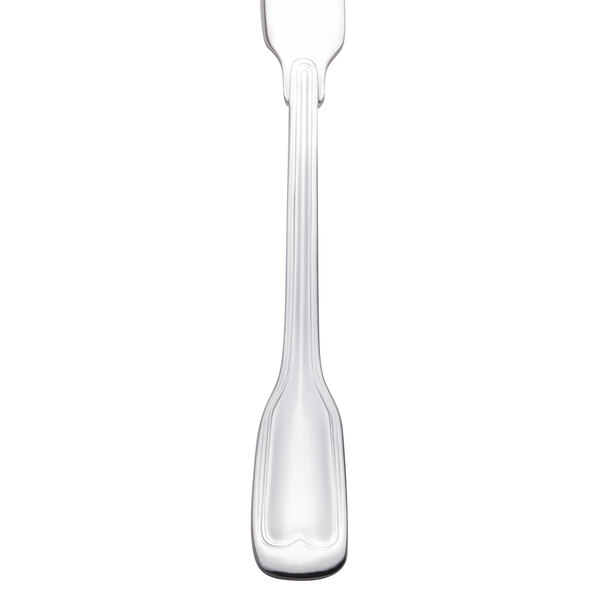 A Walco Luxor stainless steel flat handle butter spreader with a white handle.
