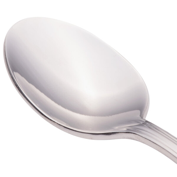 A close-up of a Walco Pacific Rim stainless steel demitasse spoon with a silver handle.