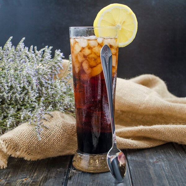 A glass of iced tea with a lemon slice and a Walco stainless steel iced tea spoon.