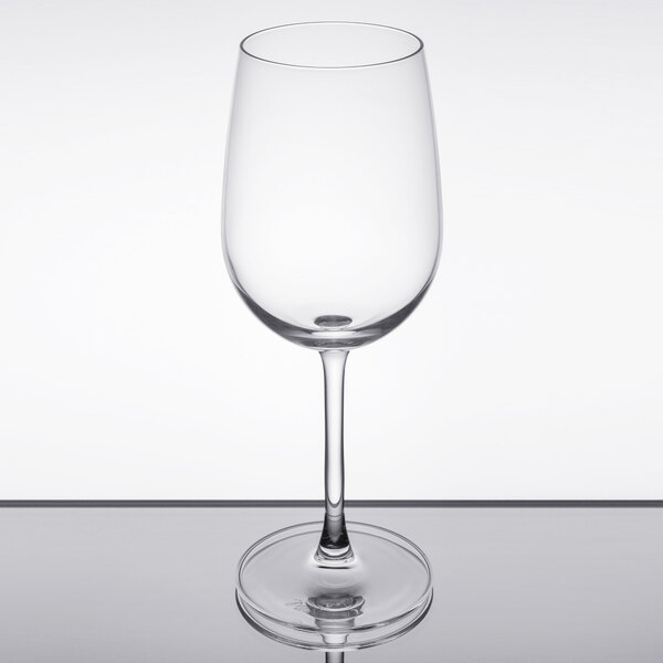 A clear Reserve by Libbey wine glass on a reflective surface.