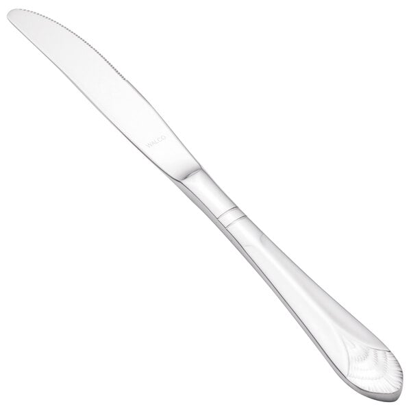 A Walco stainless steel dinner knife with a white handle.