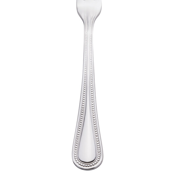 A Walco stainless steel cocktail fork with a beaded design on the handle.