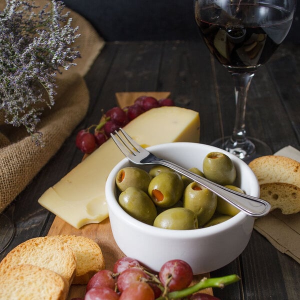 A Walco Lisbon cocktail fork in a bowl of green olives.