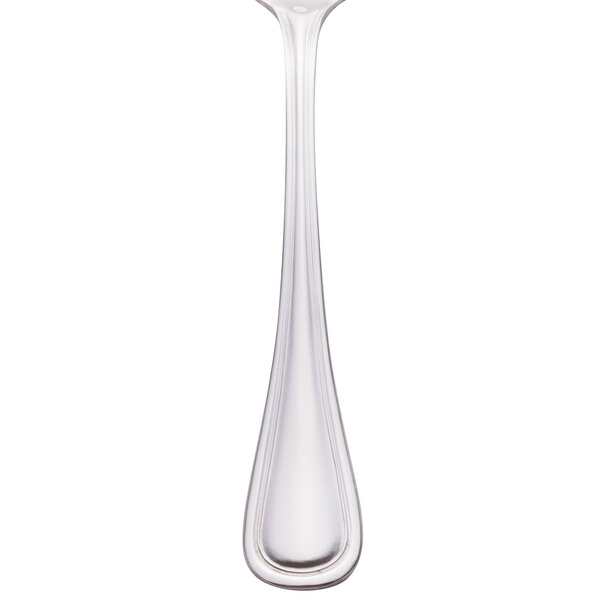 A close-up of a Walco stainless steel bouillon spoon.