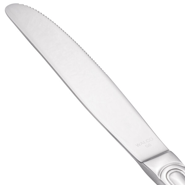 A close-up of a Walco Saville stainless steel dinner knife with a silver handle and blade.