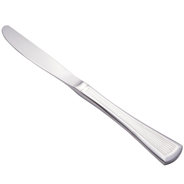 A Walco Bosa Nova stainless steel dinner knife with a white handle.