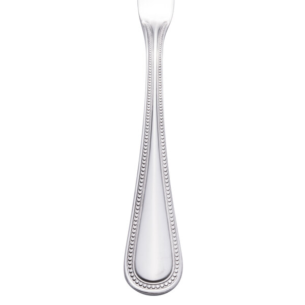 A Walco stainless steel butter spreader with a beaded design on the handle.