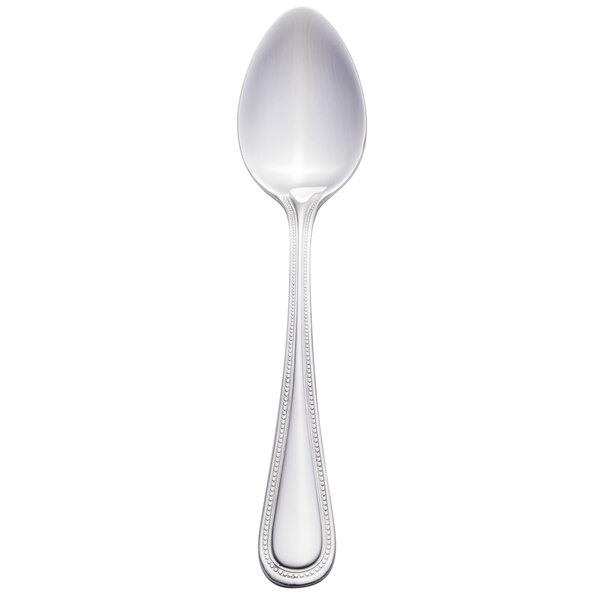 A close-up of a Walco stainless steel dessert spoon with a handle.