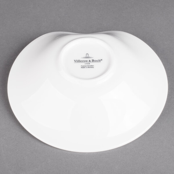 A Villeroy & Boch white porcelain deep bowl on a gray surface.