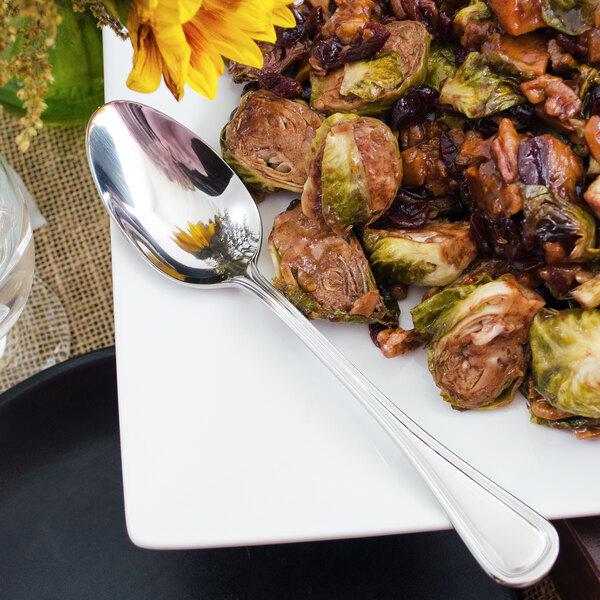 A plate of food with a Walco Lisbon stainless steel serving spoon.