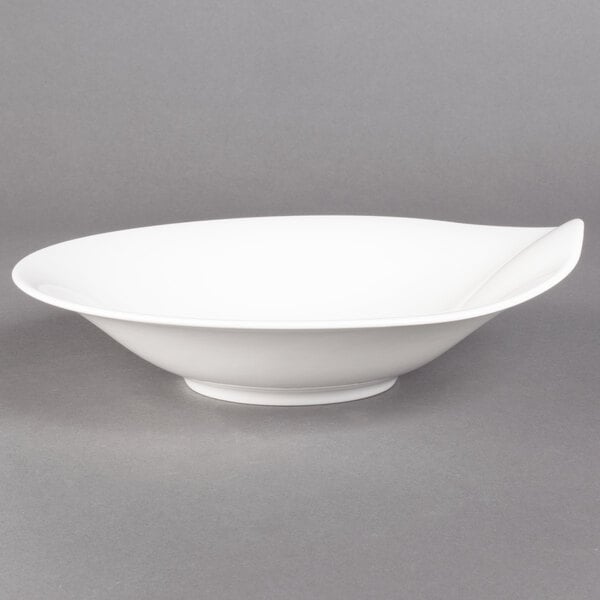A Villeroy & Boch white porcelain deep bowl with a curved edge.