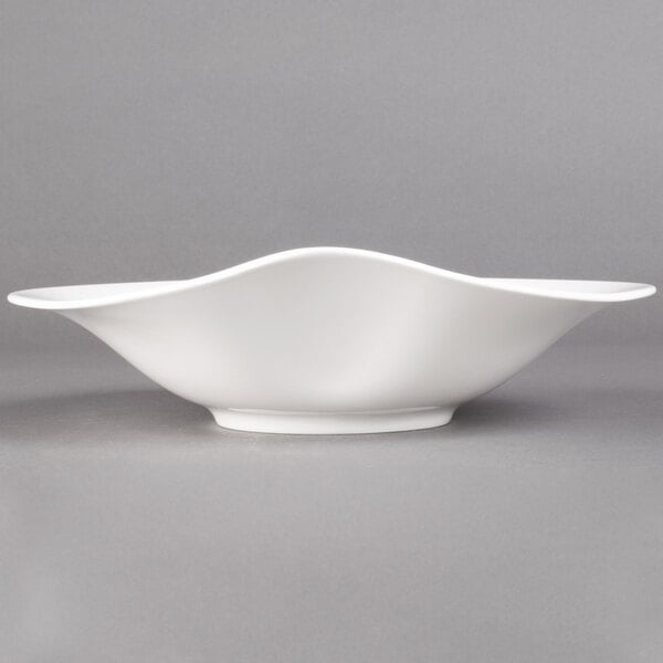 A Villeroy & Boch white porcelain deep bowl with a curved edge.