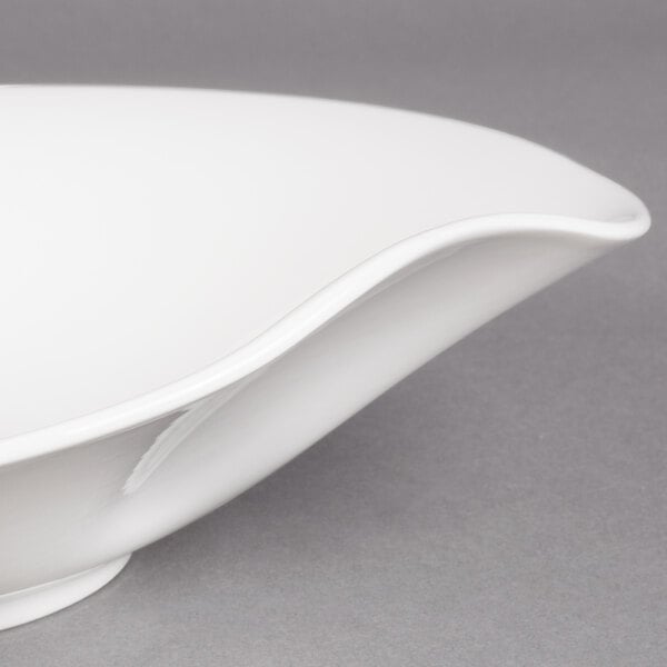 A Villeroy & Boch white porcelain deep bowl with a curved edge.