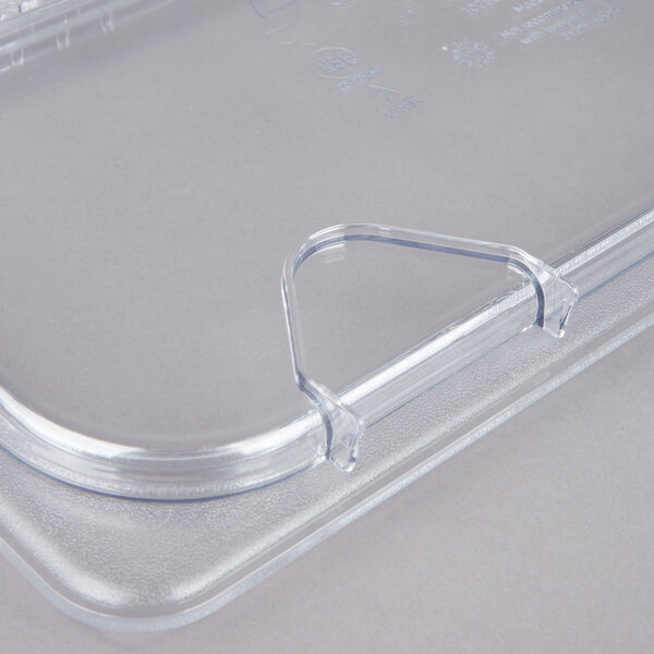 A Carlisle clear polycarbonate hinged lid on a clear plastic container.