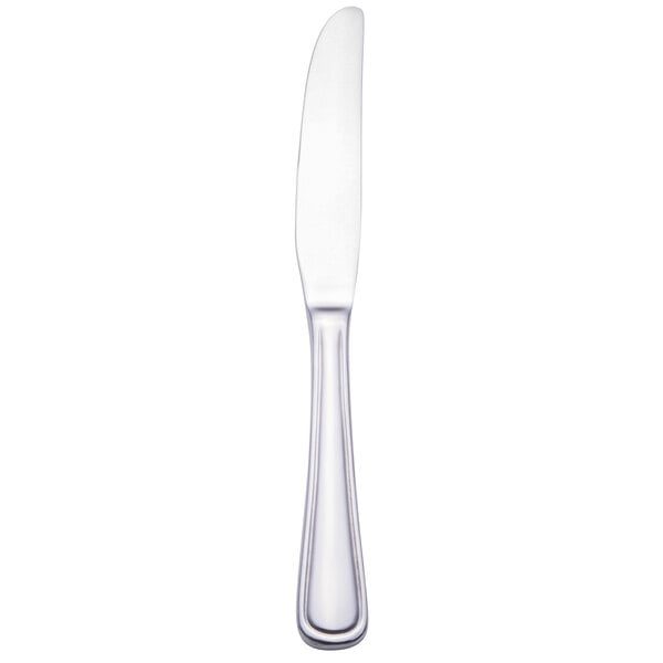 A silver Walco stainless steel European table knife with a black edge on a white background.