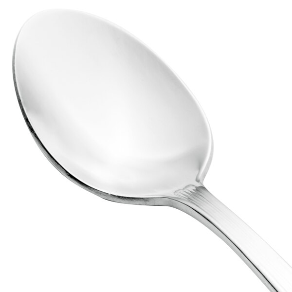 A close-up of a Walco stainless steel teaspoon with a silver handle.