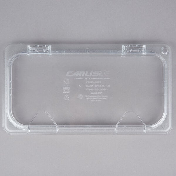A clear plastic case with a clear plastic container lid with text and two notches.